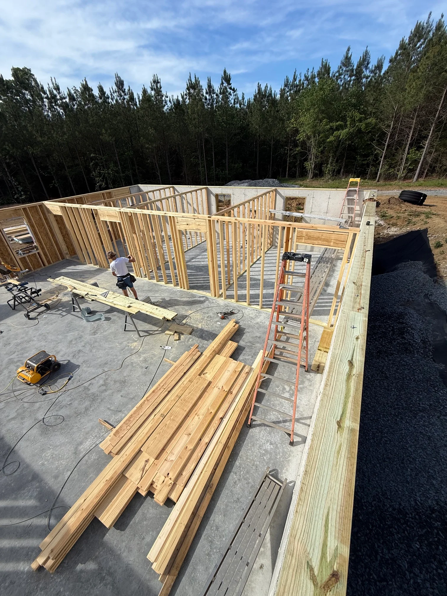 Wooden stud framing and concrete foundation for residential construction project